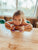 little kid eating a chocolate chip pumpkin muffin