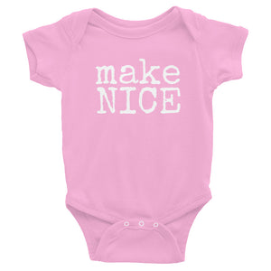 pink gender neutral baby Ivy & Co. onesie with white writing that says make nice