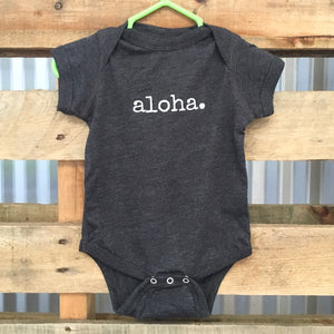 dark grey gender neutral baby Ivy & Co. onesie with white writing that says aloha