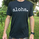 man with watch wearing a black tshirt that says aloha in white font