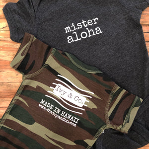 dark grey and camouflage baby boy Ivy & Co. onesie with white lettering that says mister aloha
