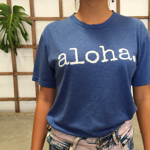 woman wearing a blue aloha tshirt with bleached jean shorts
